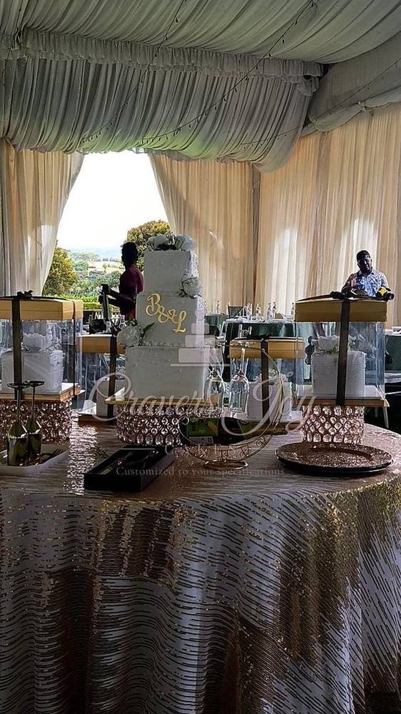 Wedding cake table in a white tent by Cravers Joy Cakes, Juja
