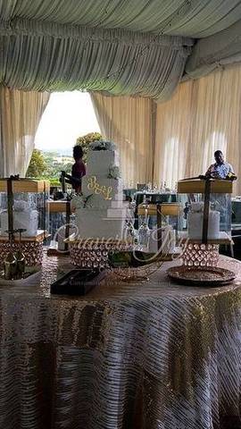 Wedding cake table in a white tent by Cravers Joy Cakes